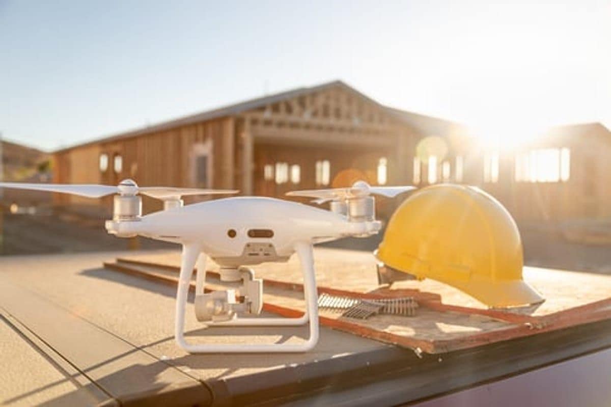 Drone and hard hat set up for a professional roof inspection on a residential rooftop