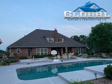 Large hip roof installed on a brick estate home with pool in South-Central Kansas