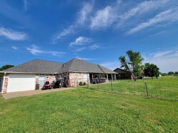 Full roof replacement on a country home and outbuilding in rural Kansas