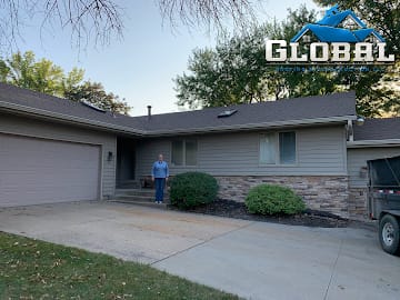 Siding, stone front, and shingle roofing renovation on a Kansas home